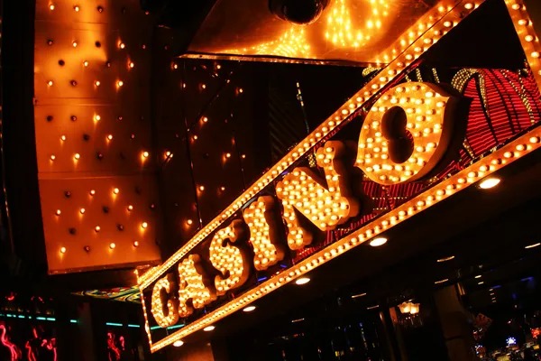 Live casino studio with multiple game tables and dealer stations